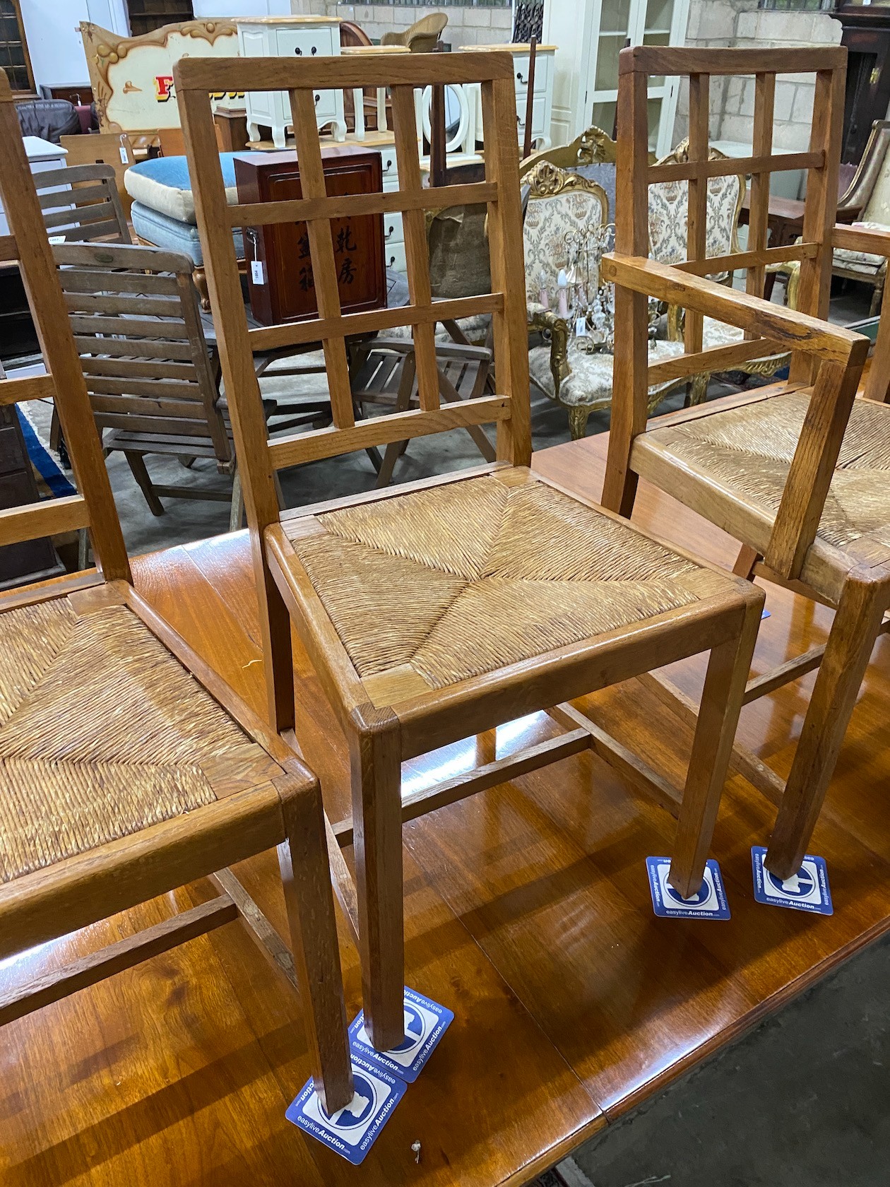 A set of five Heals Cotswold oak dining chairs, including one carver